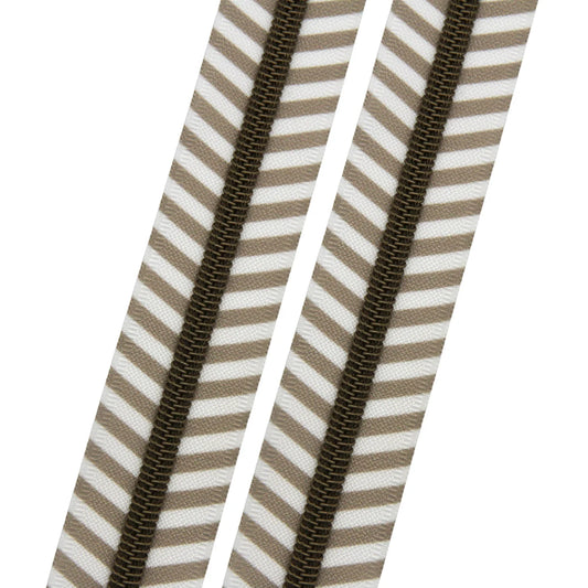 Close-up of a brown zipper on beige and white striped fabric